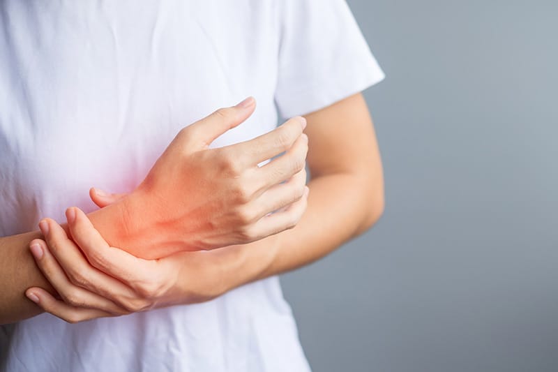 woman holding her wrist pain because using smartphone or computer long time quervain s tenosynovitis intersection symptom carpal tunnel syndrome or office syndrome conceptjpg